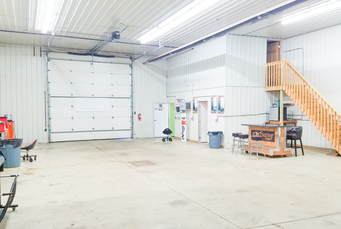 Lower level of warehouse shop showing office area / reception and bathroom entrance.