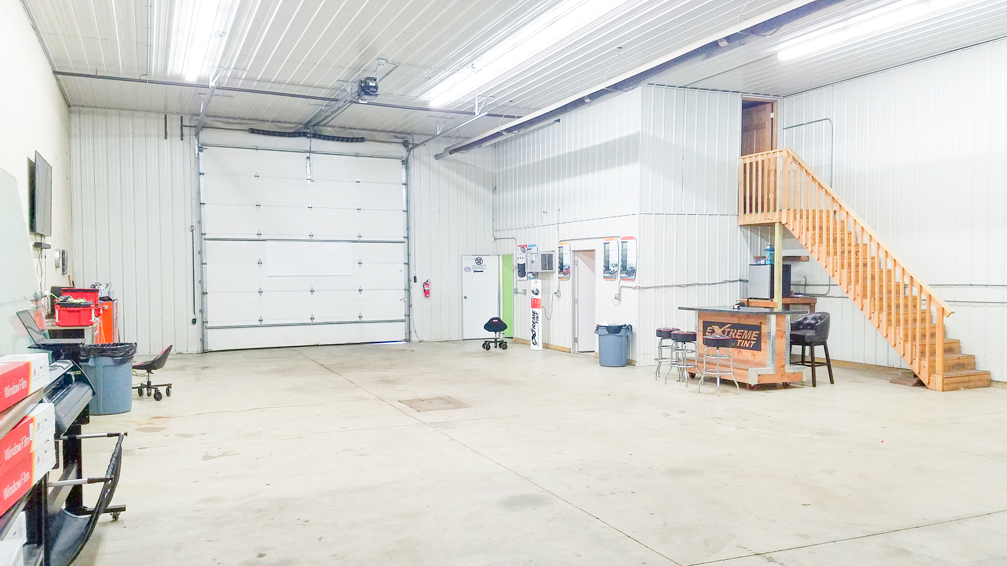 Lower level of warehouse shop showing office area / reception and bathroom entrance.