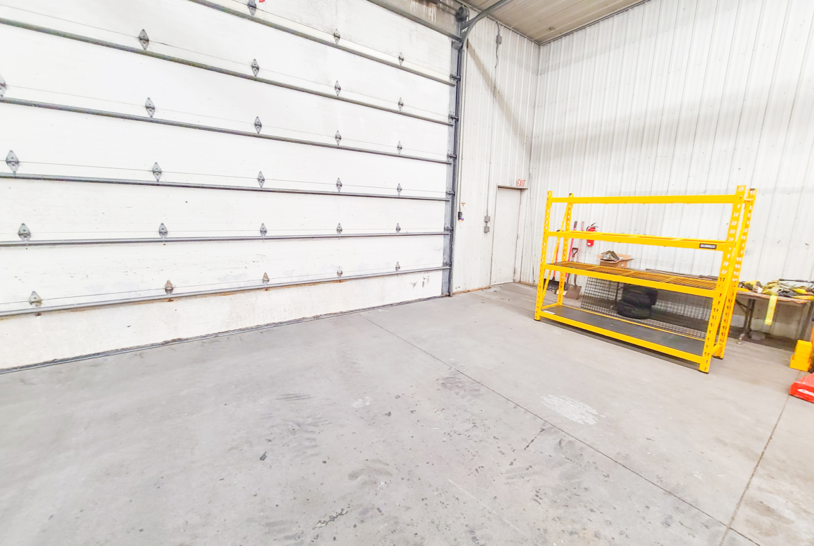 Large 16' wide garage door fits semi trucks and contractor equipment.