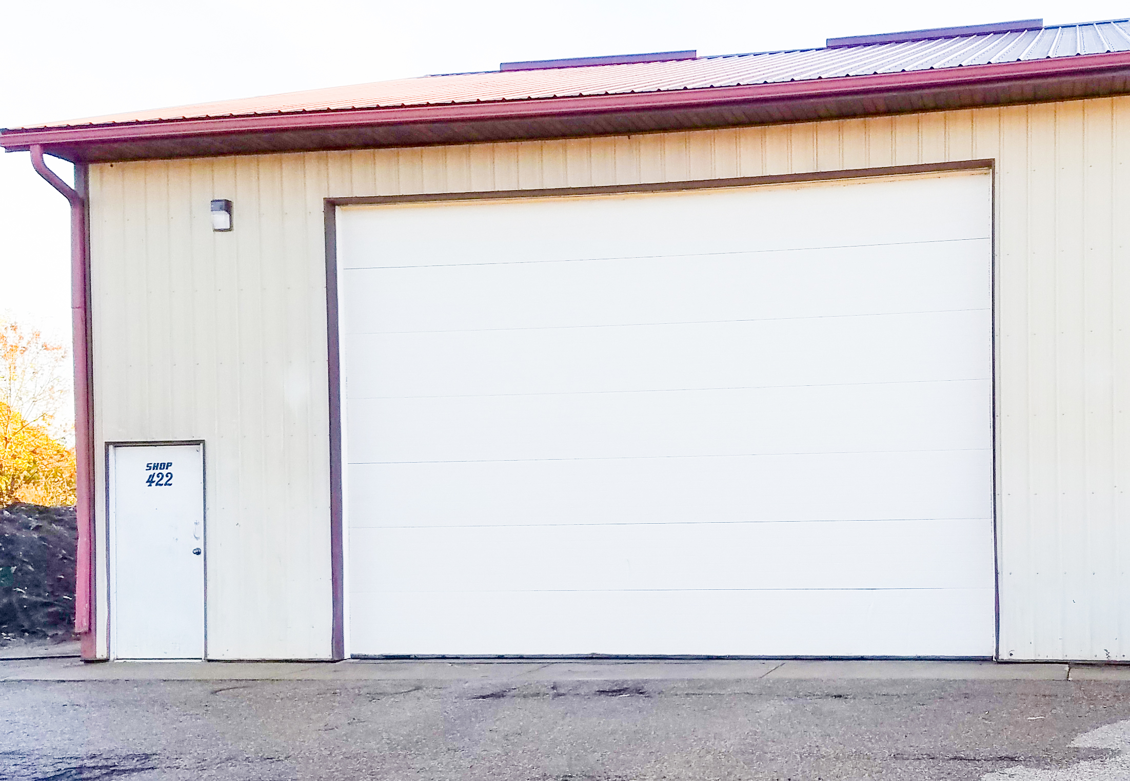 Large garage door and steel entry door on this warehouse is suitable for semi truck detailing near Waite Park, MN.